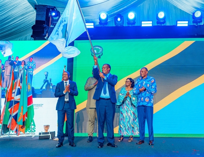 Formal congress ceremony with Tanzania stage backdrop and flags